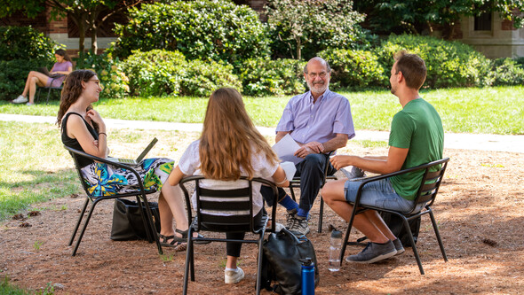 Jim Silk teaching outside with three students