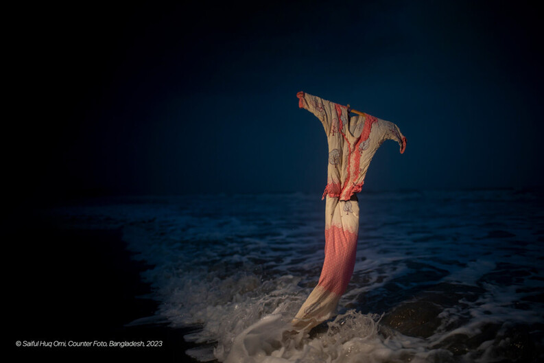 pink and cream colored dress against ocean waves at night