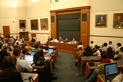 Students sitting in Yale Law School classroom watching guest speakers seated at front of class.