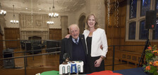 Guido Calabresi and Heather K. Gerken in front of a large cake shaped like Italy