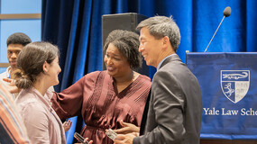Stacey Abrams and Goodwin Liu talk to a fellow alum at the Diversity Homecoming